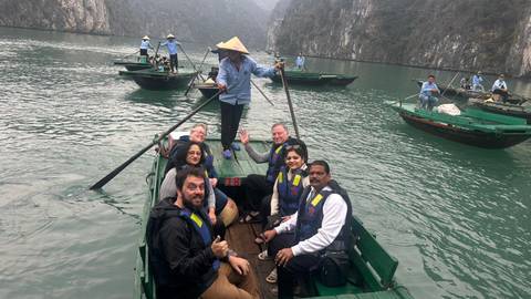 Tourists on small boats enjoying a leisurely boat ride on a tranquil lake.