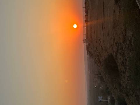 Sunset view with visitors at a high vantage point.