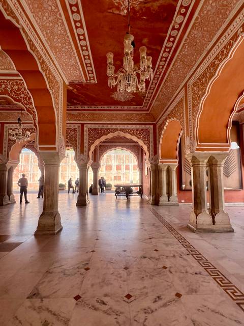 Indoor architectural view with pillars and ornate carvings.