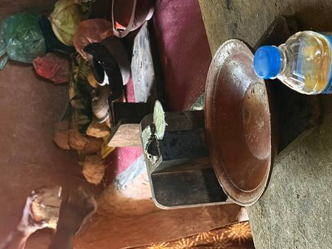 Rustic market interior featuring a traditional balance scale, clay bowl and a plastic water bottle.