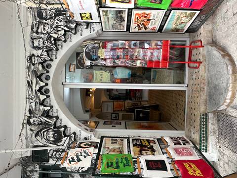 Eclectic storefront in Tangier decorated with black-and-white murals and postcards