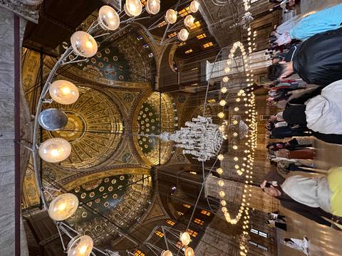 Lavish interior of the Muhammad Ali Mosque with ornate chandelier and golden dome