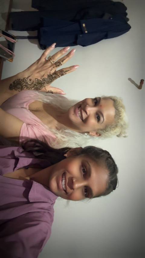 Woman and young girl smiling together for a selfie indoors