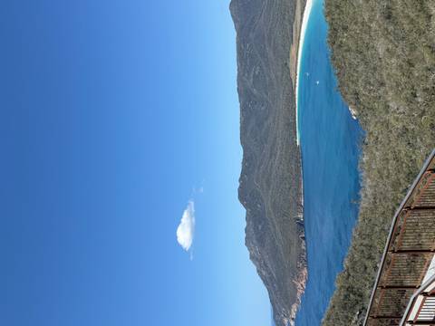 A sweeping viewpoint overlooks Wineglass Bay's brilliant blue waters and white-sand beach.