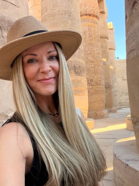 Close-up selfie of a woman inside ancient sandstone columns