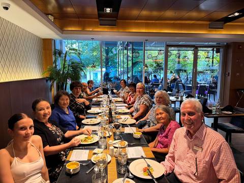 Large tour group enjoying a dinner together inside a modern restaurant setting