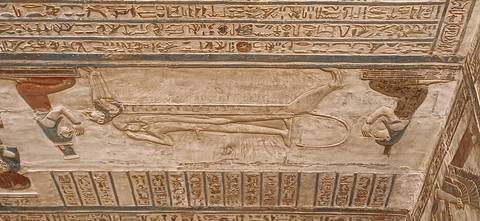 Relief of a recumbent deity on a lioness with flanking gods and hieroglyphs above