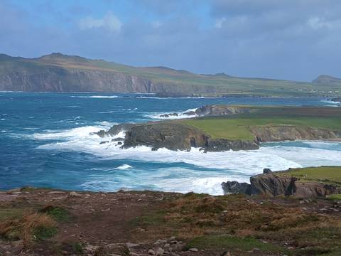 Wild Atlantic waves crash against rugged cliffs along Ireland’s dramatic coastline.