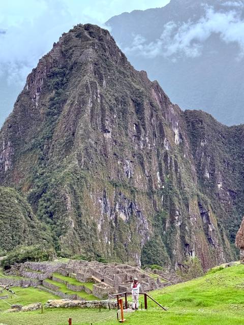 Close-up of steep, green-covered Huayna Picchu mountain peak at Machu Picchu.
