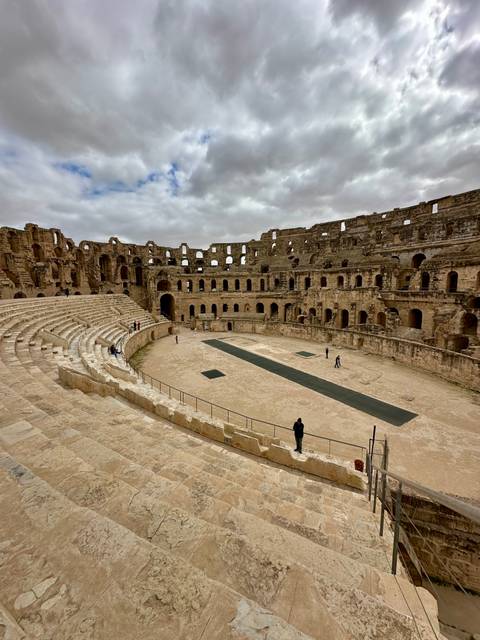 Interior view of the well-preserved Roman amphitheatre at El Jem showing tiered seating and arena floor.