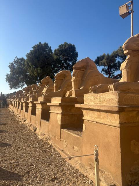 Long row of ram-headed sphinx statues along the avenue leading to Karnak Temple