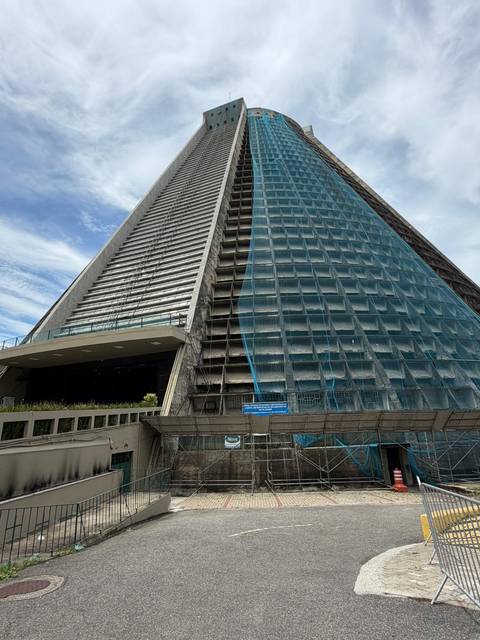 Exterior of Rio's modernist Metropolitan Cathedral partially covered with construction netting.