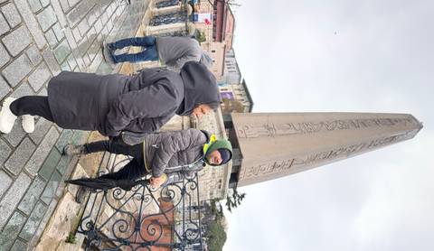Travellers in winter gear stand before Istanbul’s ancient Obelisk of Theodosius in the Hippodrome square.