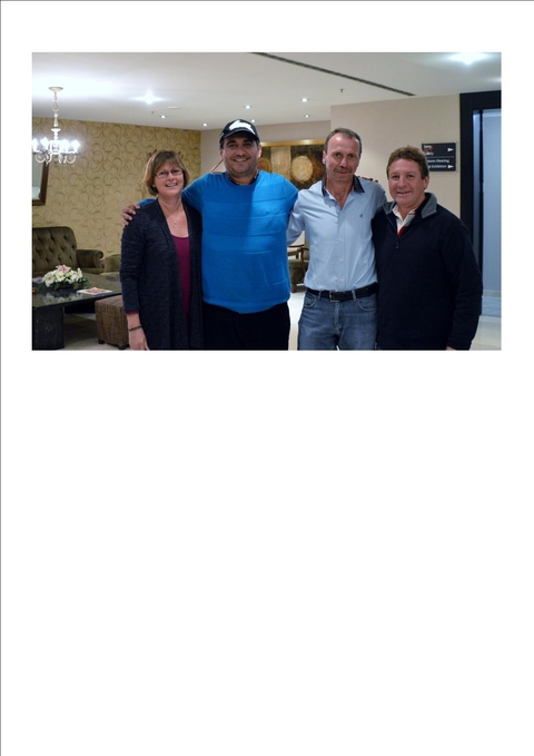 Group of three people posing, heavily cropped.