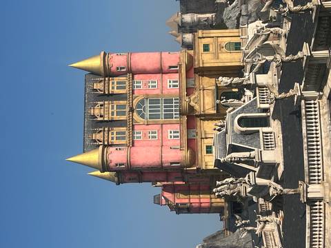 Fantasy-style pink castle with golden turrets in the French Village at Ba Na Hills.
