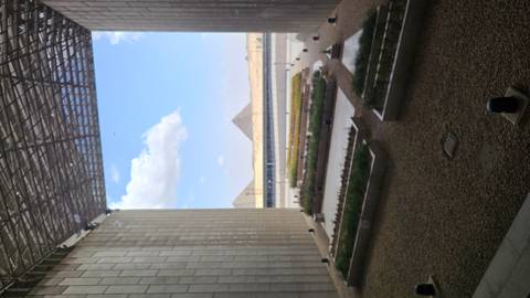 Framed museum window perfectly aligning the distant pyramids across the desert horizon.