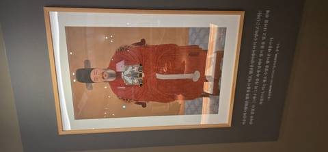 Museum display of historical Korean portrait painting with descriptive text beneath.