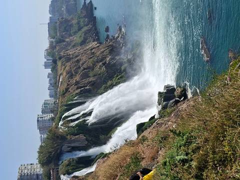 Powerful coastal waterfall plunging from city cliffs into turquoise Mediterranean