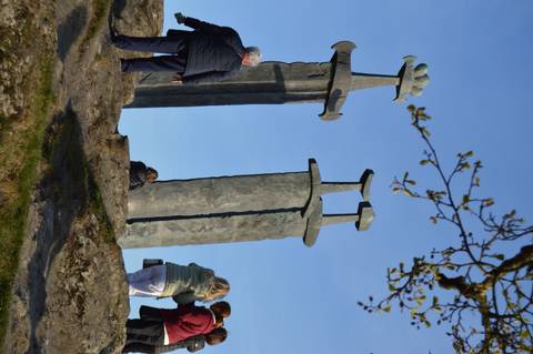 Large Viking sword monuments embedded in a rocky hilltop at Sverd i Fjell under clear skies