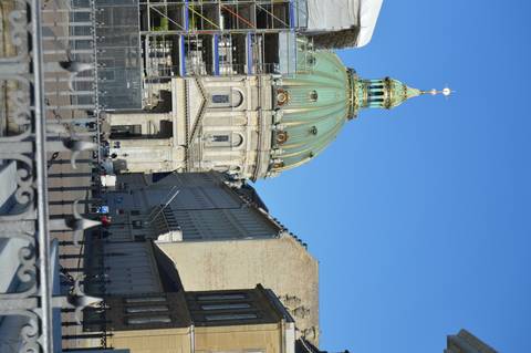 Green-domed Marble Church rises above Copenhagen street under clear blue sky