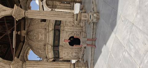 A visitor poses barefoot in the ornate marble courtyard of Cairo’s historic mosque at the Citadel.