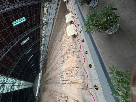 Vast hangar containing rows of excavated Terracotta Warriors and horses behind protective barriers in Xi’an.