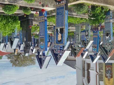 Vivid blue wooden tombstones with folk art fill Romania's Merry Cemetery.