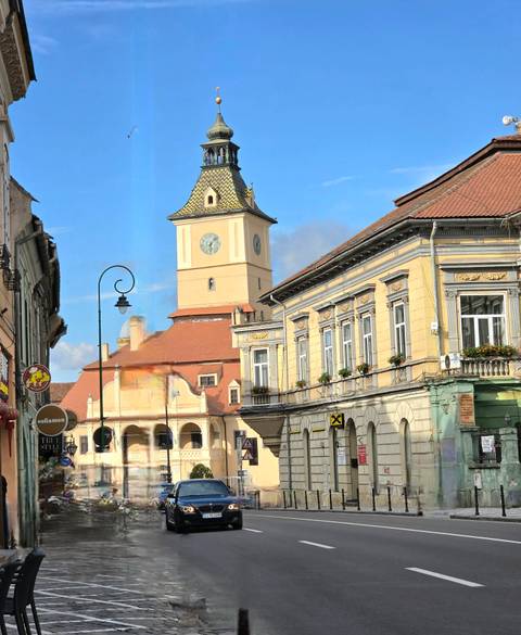 Historic Council Tower anchors a colorful street scene in Brasov's Old Town.