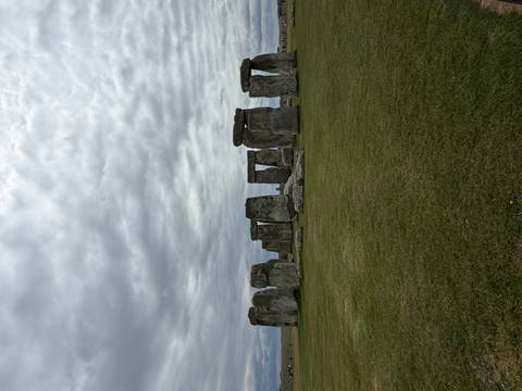 Iconic stone circle of Stonehenge under a dramatic cloudy sky