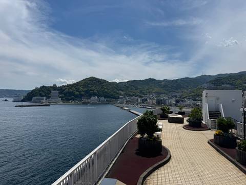 Seaside town view from elevated walkway with bay and hills beyond