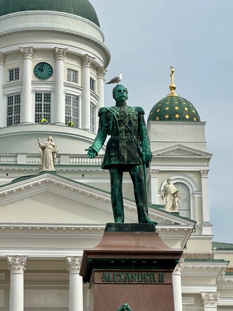 Bronze statue of Alexander II with the neoclassical Helsinki Cathedral domes in the background