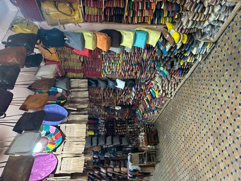 Stacks of vividly coloured leather slippers and handbags fill every inch of a tiny medina shop.