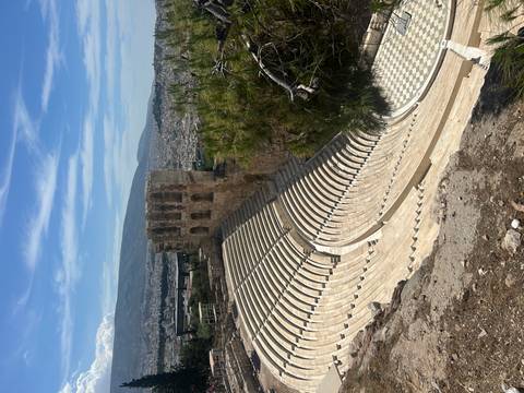 Sweeping view of the semicircular stone seating of the Odeon of Herodes Atticus on the Acropolis hillside.