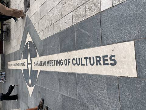 "Sarajevo Meeting of Cultures" line set into city pavement dividing architectural styles.