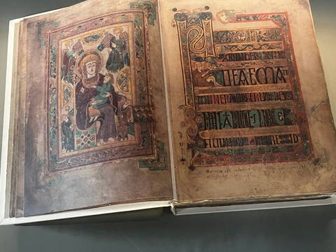 Detailed pages of an ornate medieval illuminated manuscript on display