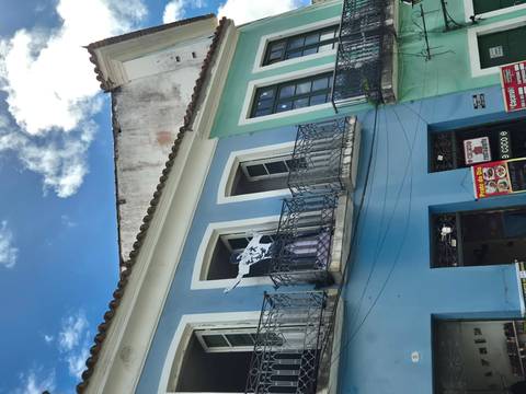 Colourful colonial blue building in Salvador’s Pelourinho district with a balcony mannequin