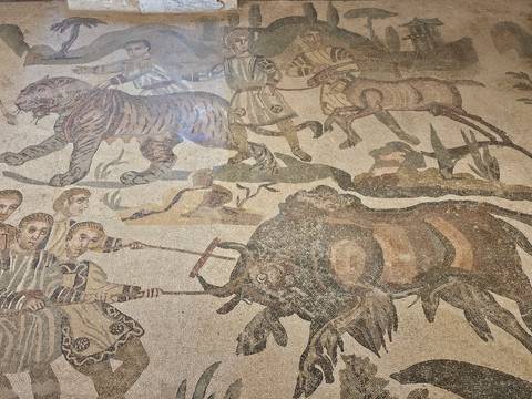 Detailed Roman hunting scene mosaic showing tigers, elephants and hunters.