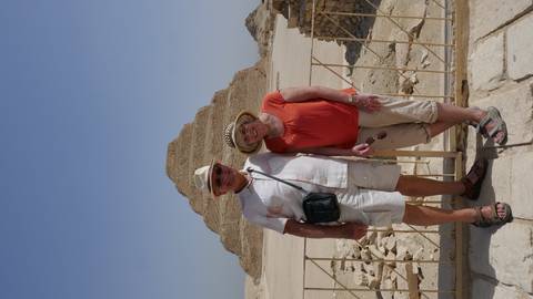 Couple posing before the Step Pyramid of Saqqara on a hot hazy day.