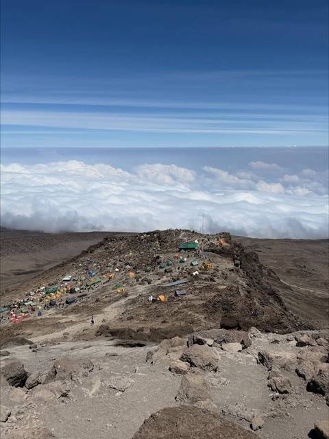 High-altitude camp on Mount Kilimanjaro above a sea of clouds.