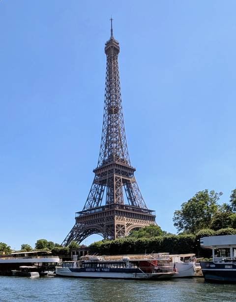 Clear daytime shot of the Eiffel Tower against a cloudless sky