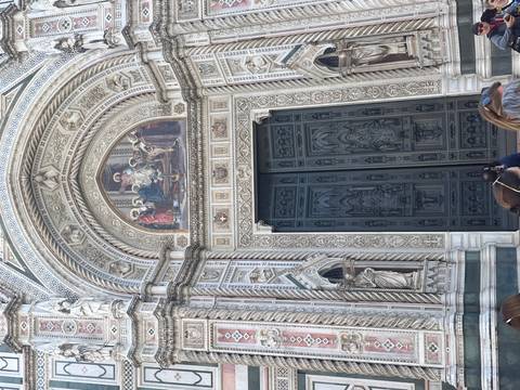 The ornate marble doorway and frescoes of Florence’s Duomo draw visitors’ attention.