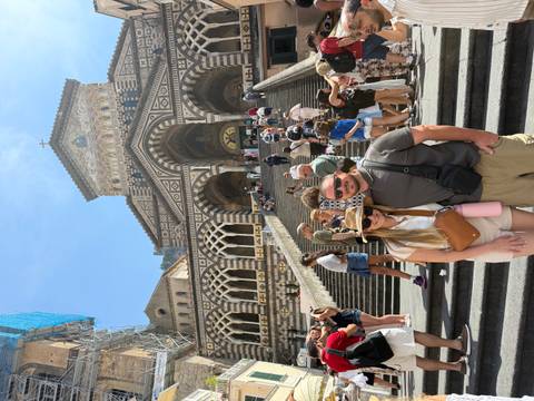 Busy staircase of Amalfi Cathedral with tourists; smiling couple stands in foreground