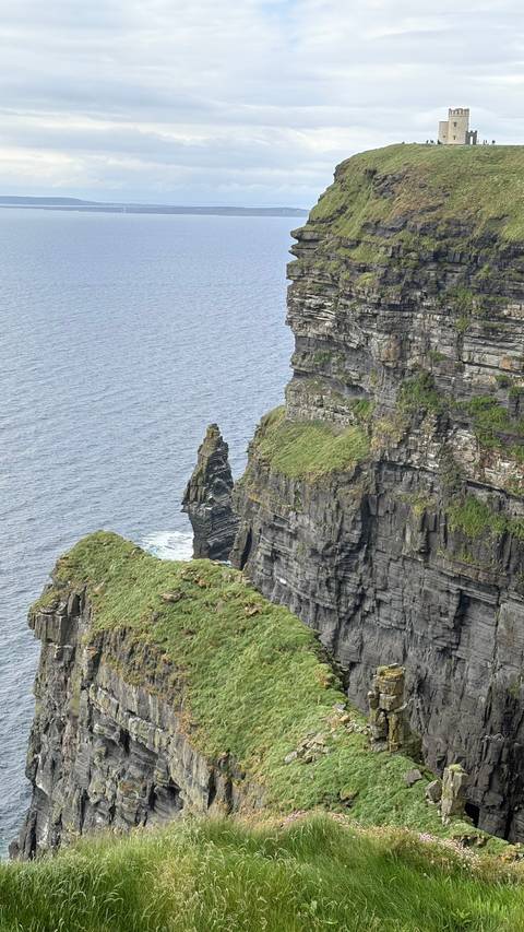 Dramatic ocean cliffs with sea stack and layered rock faces along the Atlantic coast