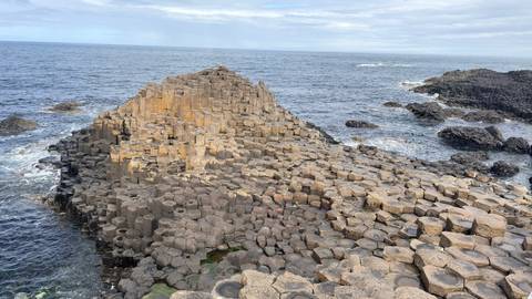 Panoramic view of Giant’s Causeway’s interlocking basalt columns stretching into the sea