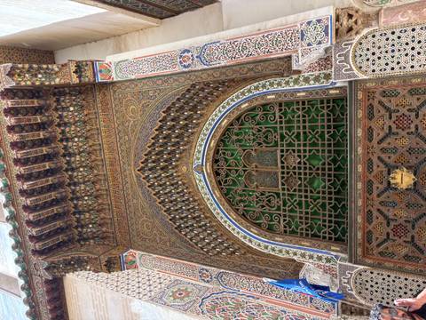 Richly decorated Islamic archway with intricate wood and tile work in Fes.