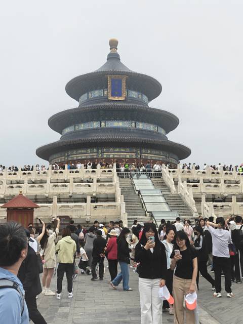 Crowd gathered at the Temple of Heaven with its circular blue-tiled hall