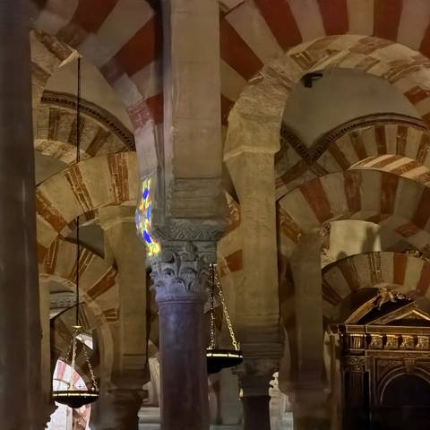 Interior view of striped horseshoe arches and columns of the Mezquita.