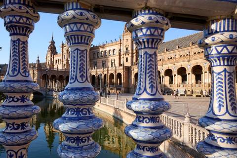 Blue and white balustrades of Plaza de España framing the grand pavilion in background.