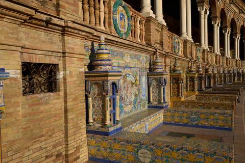 Row of colourful tiled alcoves representing Spanish provinces at Plaza de España.