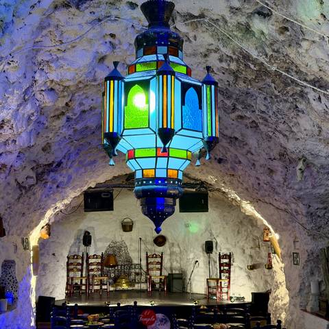 Colourful lantern hanging from a whitewashed cave ceiling in a flamenco bar.